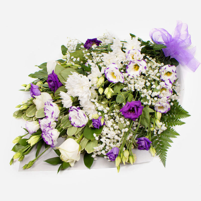 Funeral Flowers SYM-335 - Funeral Flowers in Cellophane Purple & White. 
*Fine Print: Every product is hand made and delivered by the local florist. Pictures shown are recent examples of an actual arrangement that was designed by talented florists! Please note that each individual florist cannot guarantee what the flower varieties or colours will be (unless specified on the product description), they will guarantee that your specific arrangement will be fresh and beautiful.