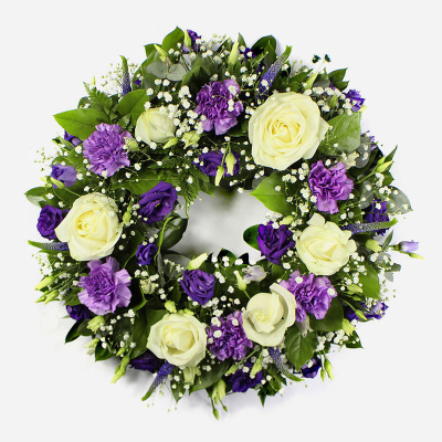 Wreath SYM-316 - Classic Wreath in Purple & White. Approx size - 30cm / 12” Oasis Wreath Frame. 

*Fine Print: Every product is hand made and delivered by the local florist. Pictures shown are recent examples of an actual arrangement that was designed by talented florists! Please note that each individual florist cannot guarantee what the flower varieties or colours will be (unless specified on the product description), they will guarantee that your specific arrangement will be fresh and beautiful.